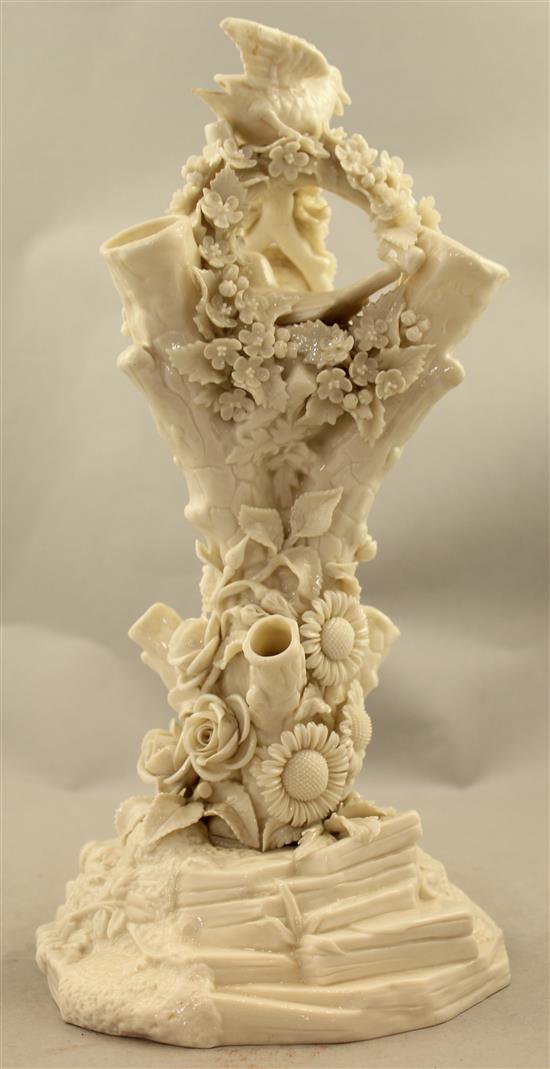 A Belleek bird and nest on a stump vase, late 19th century, 32cm, loss to bird